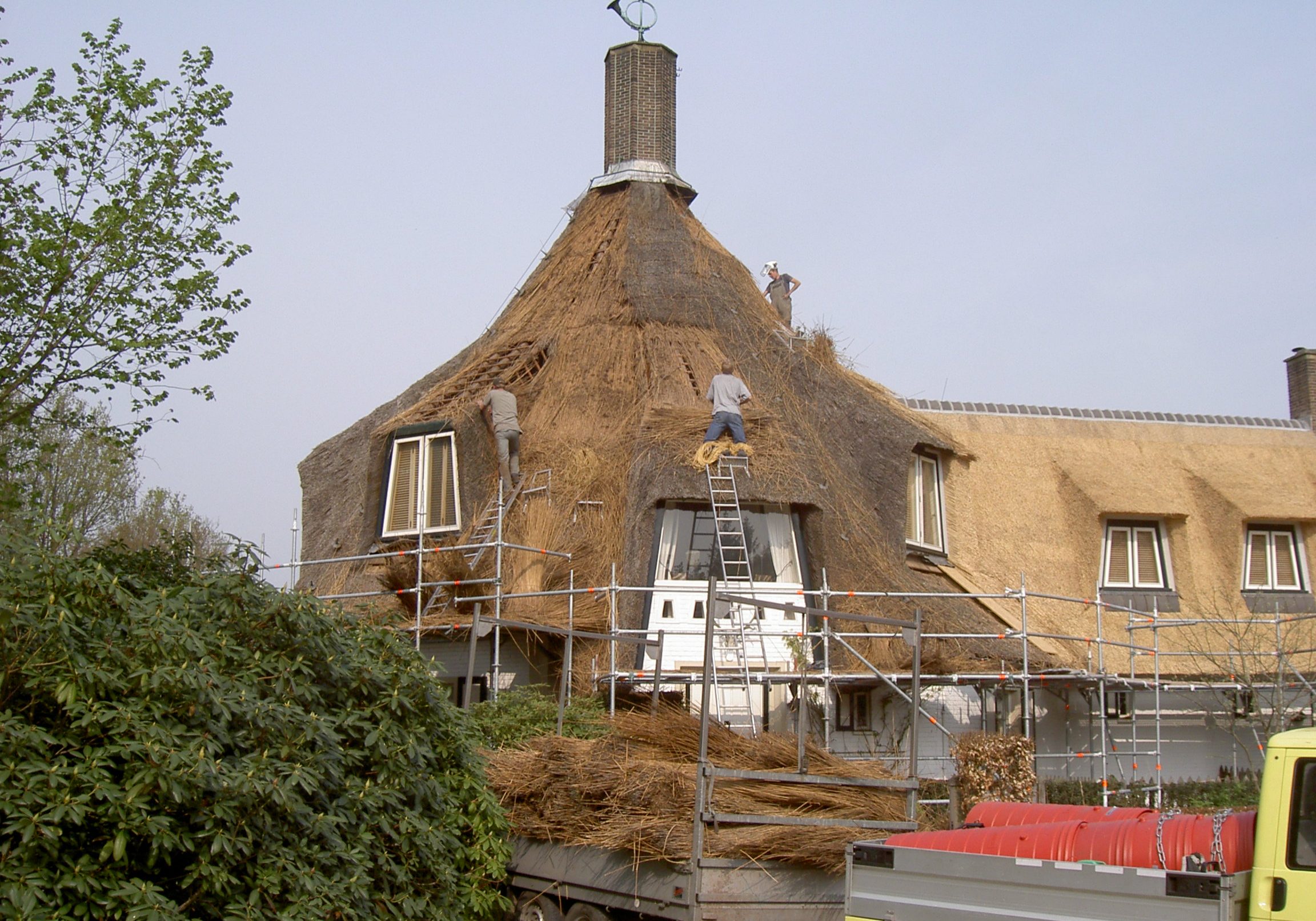 Rietafval wat vrij komt tijden het slopen van het oude rietendak. Het riet is hier vervuilt met stukken bindingsdraad en puin.
